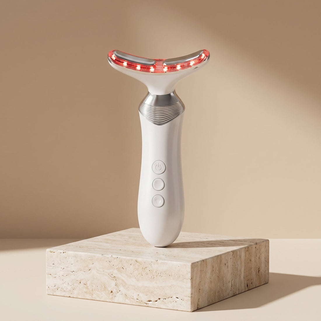 AuraZen LED face and neck device on a travertine pedestal