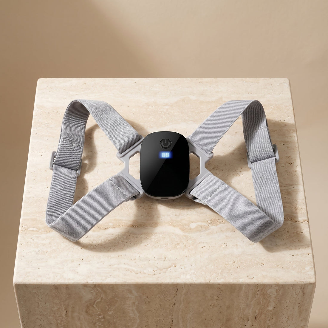 PostureZen smart posture trainer with black module on a travertine pedestal