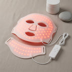 GlowZen LED face and neck mask glowing with red light