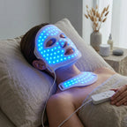 Woman wearing the GlowZen LED face and neck mask glowing with blue light