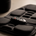 Close-up of the ChairZen wired handheld remote on the cushion