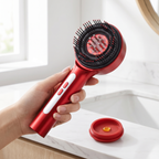 Hand holding the RelaxZen scalp massager with its oil cap
