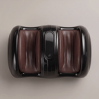 Top-down view of the CalfZen glossy black foot and calf massager