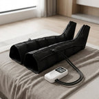 Pair of LegZen black leg boots connected by air hoses to the white handheld remote