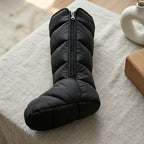 Detail of a LegZen black quilted leg boot with front zipper and enclosed foot