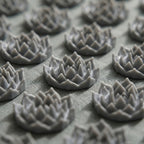 Close-up of the gray lotus spike discs on the AcuZen mat