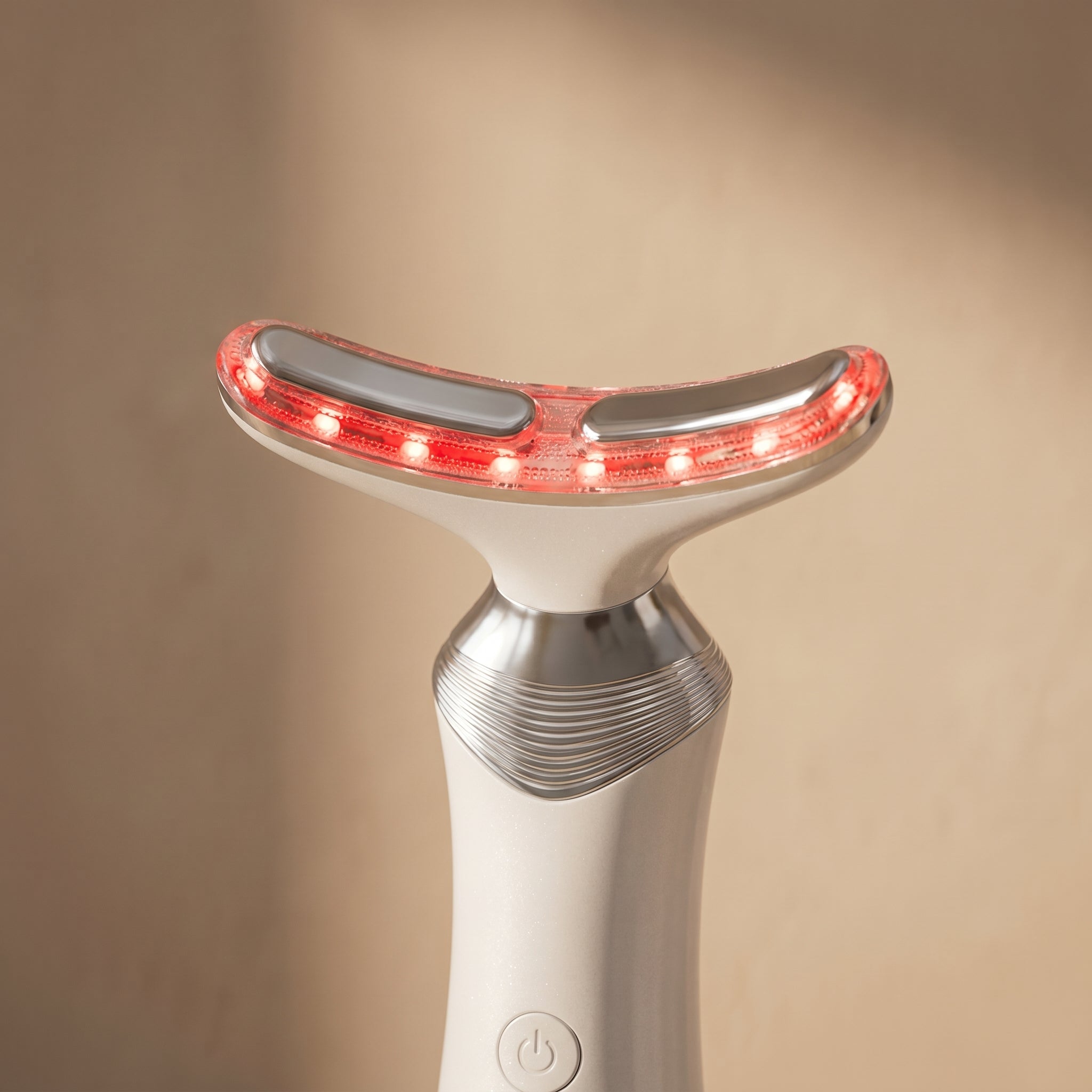 Close-up macro of AuraZen curved applicator head with red LEDs
