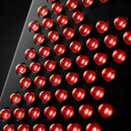 Close-up macro of BeamZen red dome LED grid in deep black housing