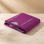 CocoonZen infrared sauna blanket in purple folded on travertine pedestal