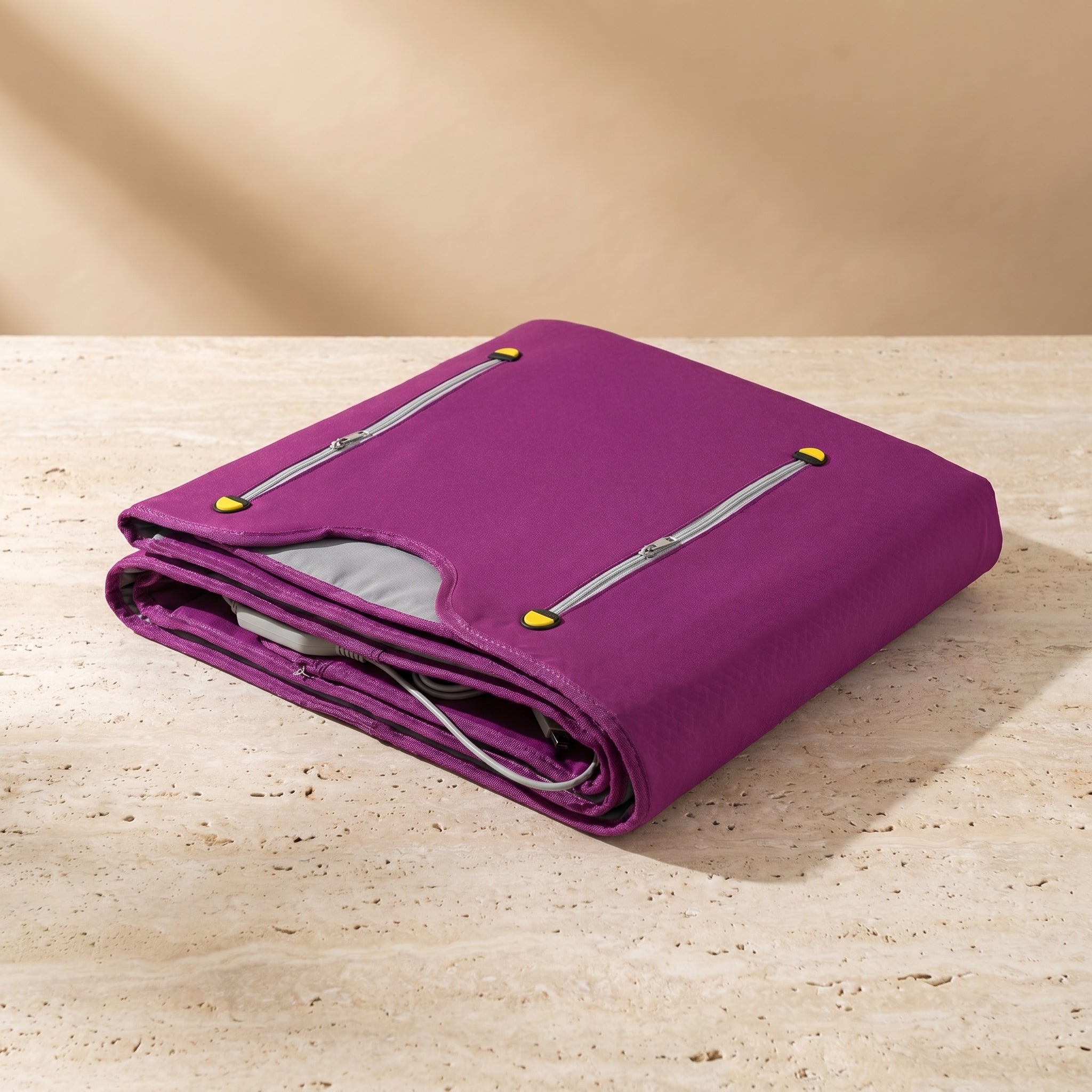 CocoonZen infrared sauna blanket in purple folded on travertine pedestal