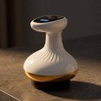 ContourZen massager on dark stone with the gold band catching warm light
