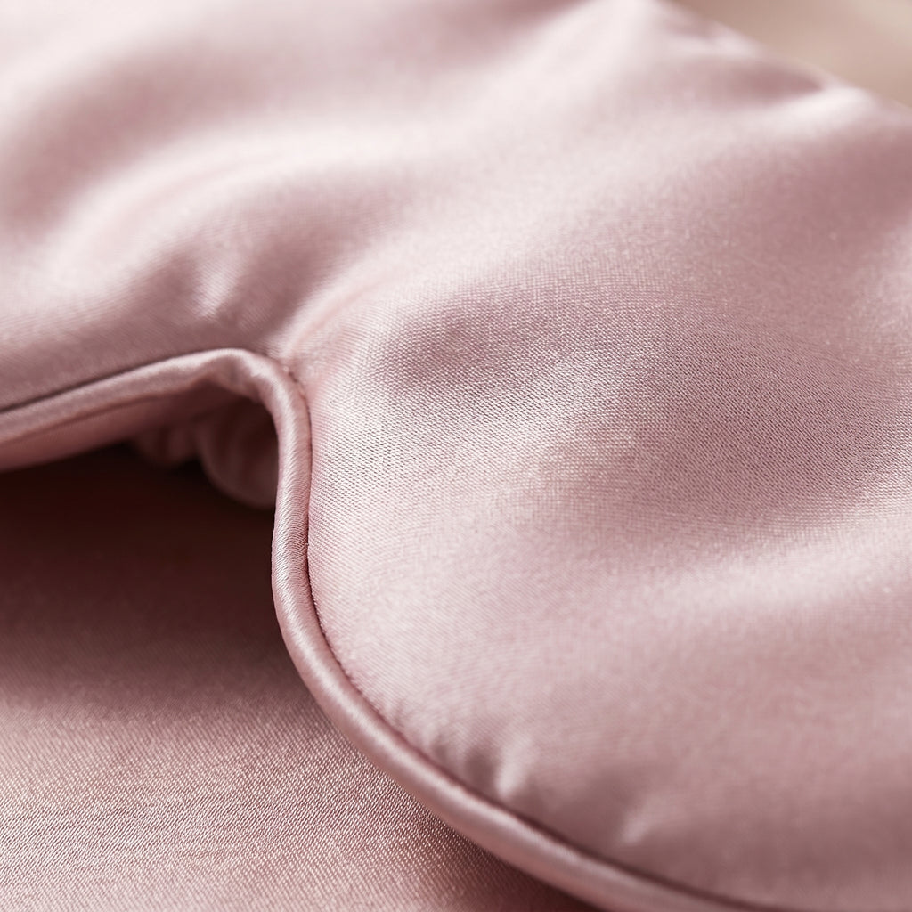 Close-up of smooth pink mulberry silk fabric and padded edge