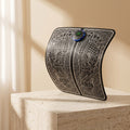 FlexZen EMS foot mat curled upright on a travertine pedestal