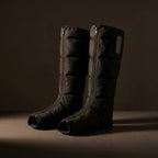 FlowZen recovery boots standing on a dark surface with soft side lighting