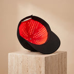 FollicZen red light LED cap interior dome tilted on travertine pedestal