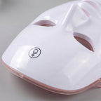 Close-up of the GlowZen mask forehead touch control and glossy shell