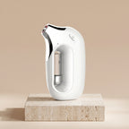 HydraZen oxygen infusion facial device in white on a travertine stone pedestal