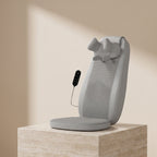KneadZen shiatsu massage seat cushion on a travertine stone pedestal