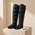 LegZen air compression leg massager boots and controller on travertine pedestal