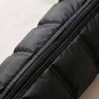 Macro detail of LegZen boot quilted fabric texture and zipper seam