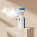 MistZen handheld facial mist sprayer on a travertine pedestal warm beige backdrop
