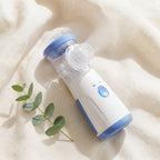 MistZen facial mist device on cream linen fabric with eucalyptus sprig