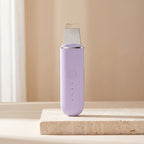 Lavender purple PoreZen sonic scrubber lit by gentle side daylight
