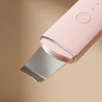 Close-up of PoreZen stainless steel spatula head and power button