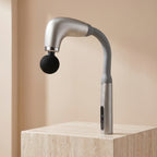 Silver PulseZen long-handle fascia massage gun on warm stone