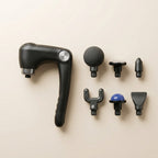 PulseZen Pro massage gun with six interchangeable attachment heads laid out on neutral surface