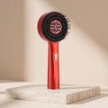 RelaxZen red light scalp comb upright on travertine pedestal studio light