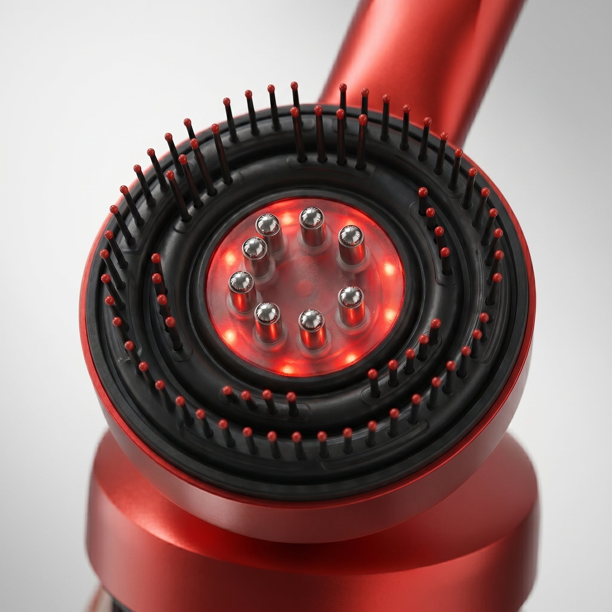 Close-up of RelaxZen comb head showing LED center and massage teeth