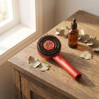 RelaxZen scalp comb on wooden vanity beside amber serum bottle