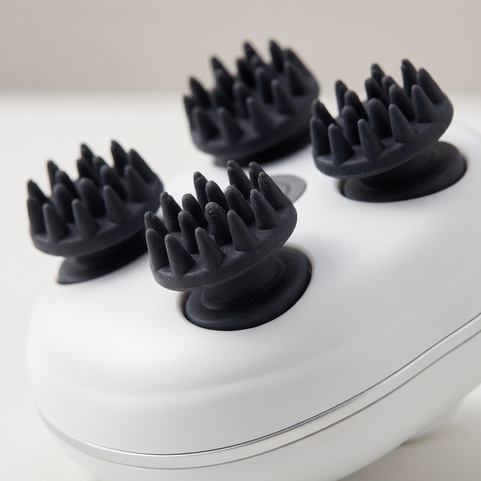 Close-up of ScalpZen rotating massage heads with flexible silicone tips