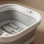 Close-up of SoakZen massage rollers and control button inside basin