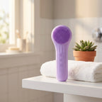 SonicZen brush standing on a white bathroom shelf with a folded towel