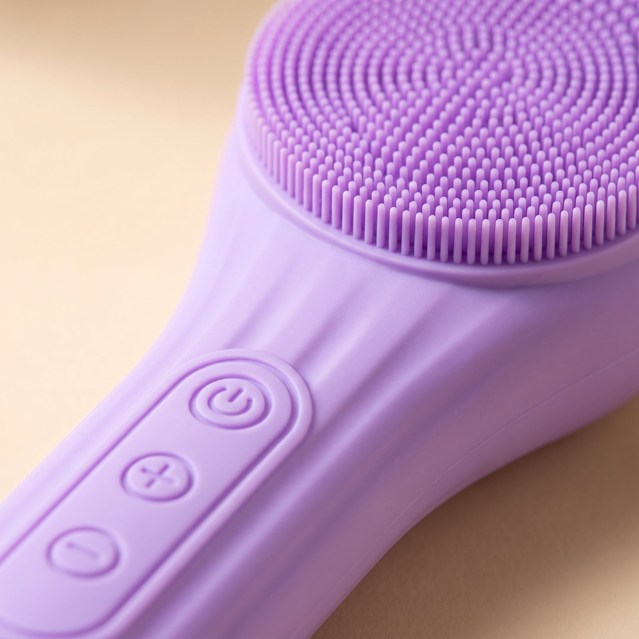 Close-up of SonicZen silicone bristle head and round control buttons